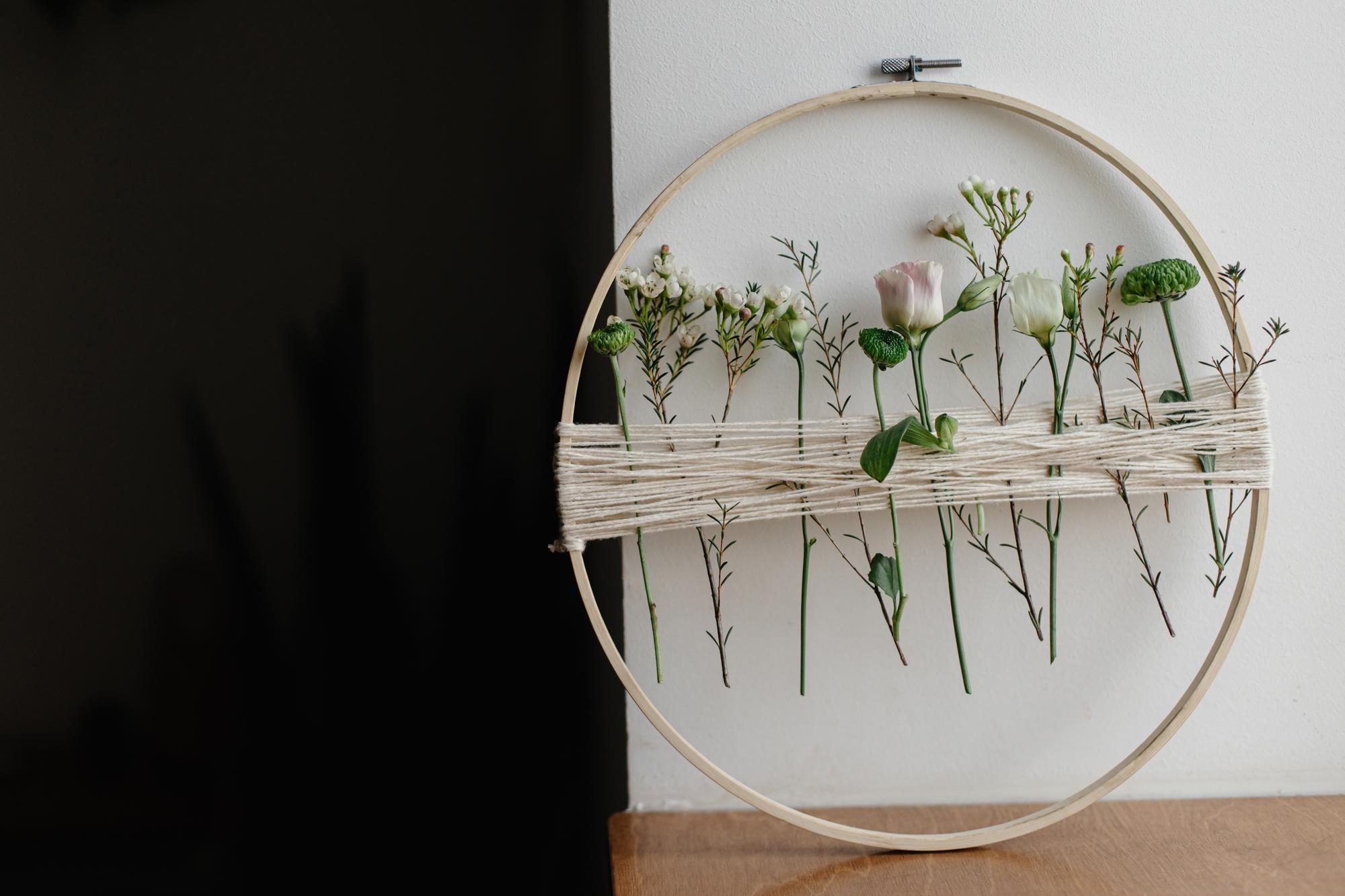 studio window with embroidered pieces on display